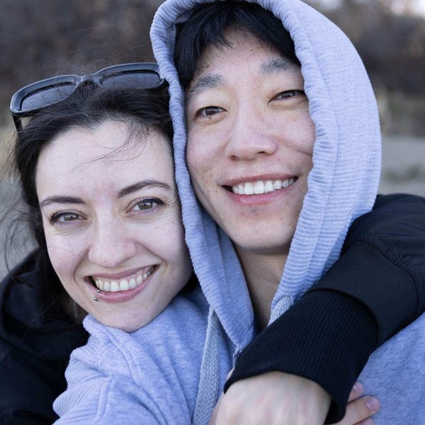 Mr and Mrs Xu — the two of them cheek to cheek in a grey hoodie, smiling
